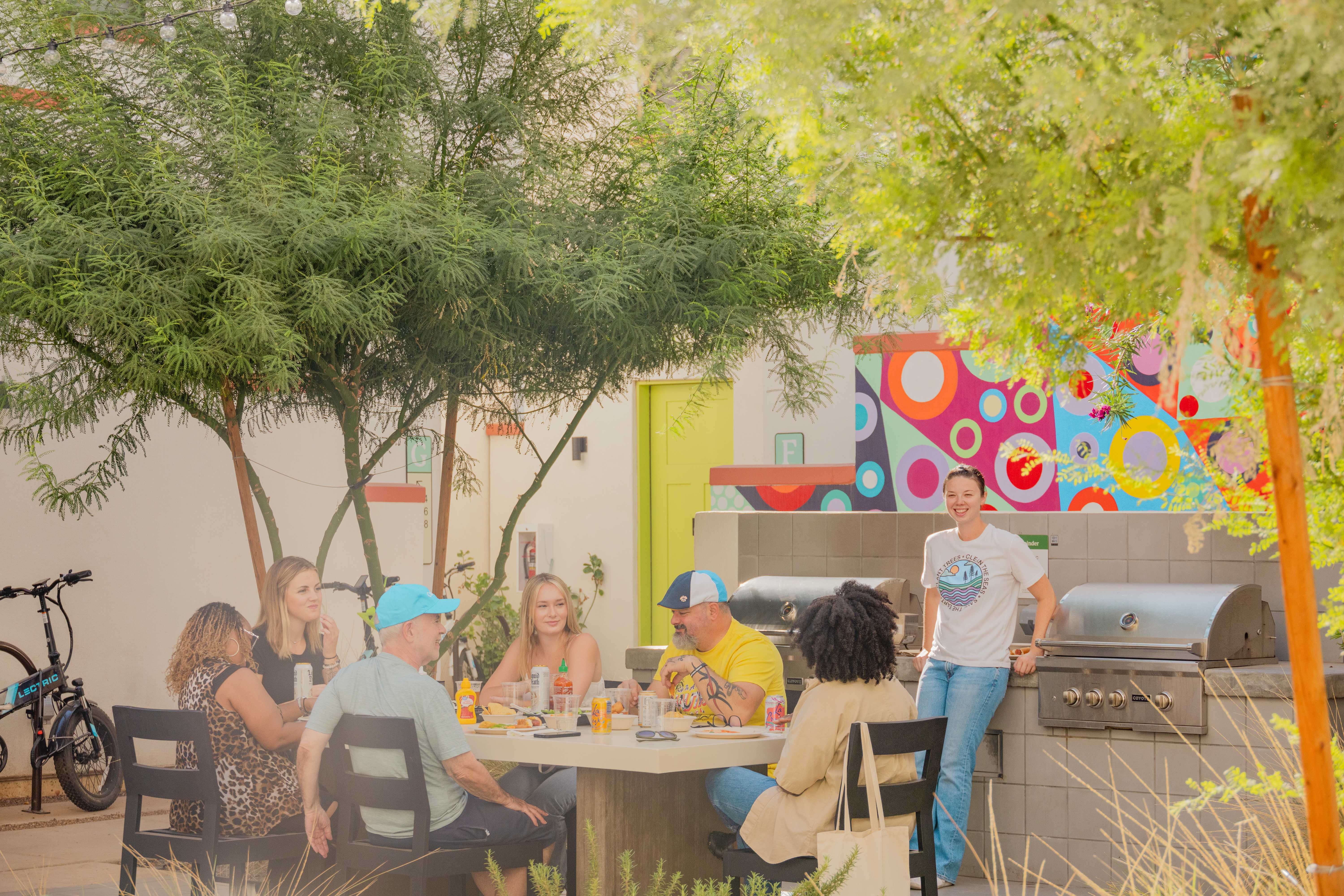 People sitting around a table in a BBQ area