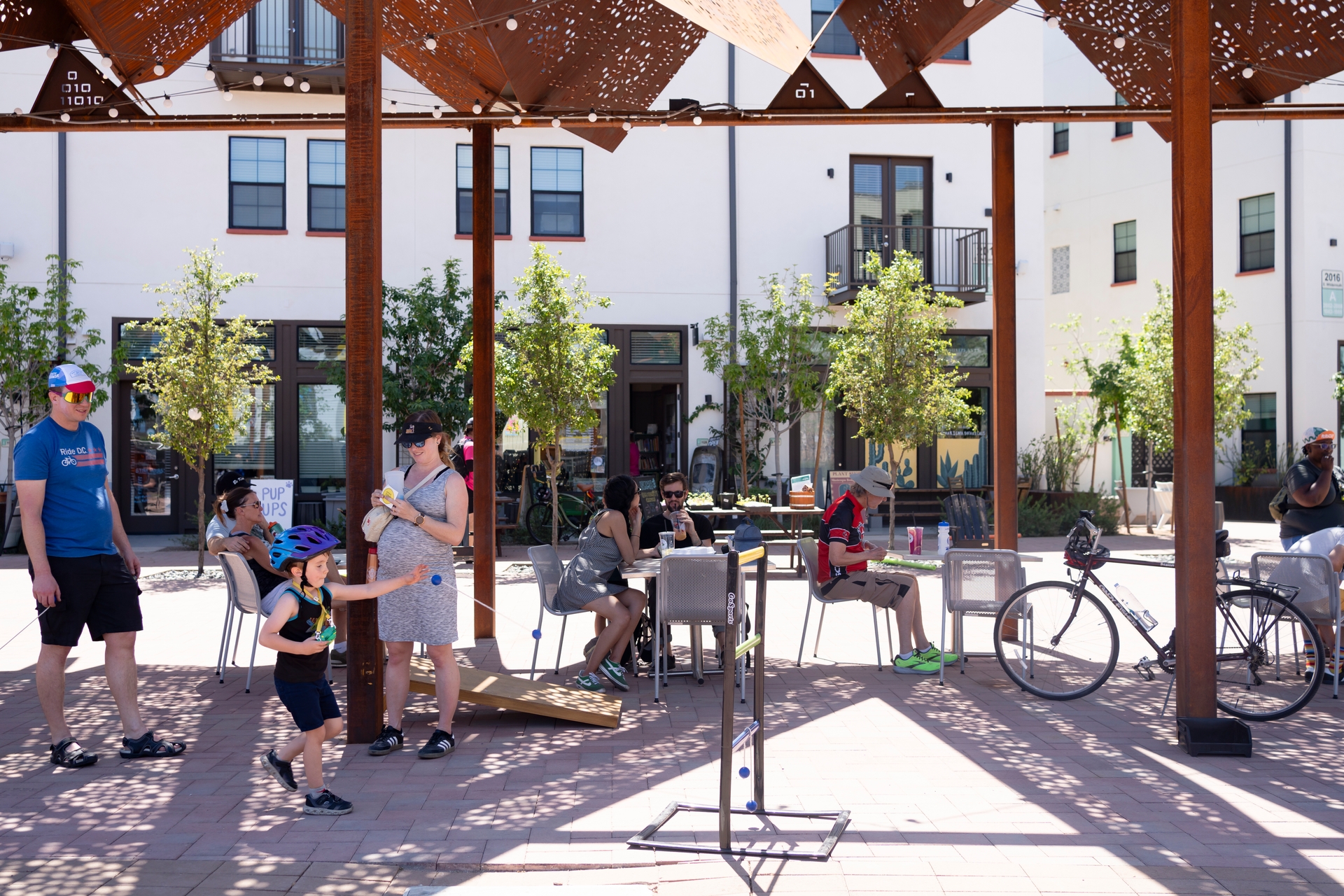 Families playing games in the outdoor plaza